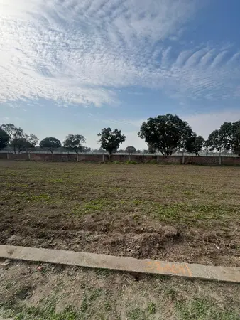 Different view of available residential plot for sale by RRB Properties with open land and boundary fencing