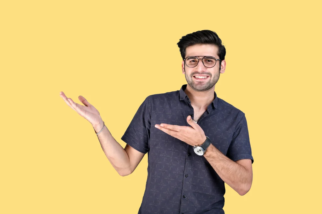 Smiling man in casual shirt pointing to the side, representing trust and confidence on a yellow background — ideal for a 'Why Choose Us' section.