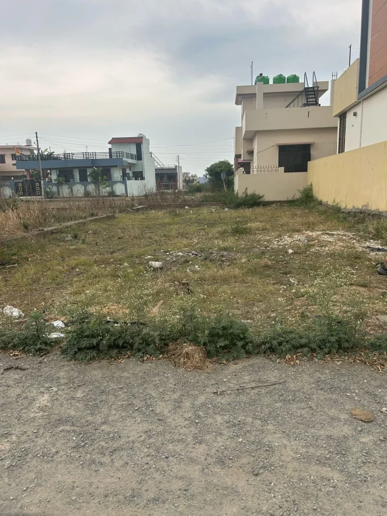 Large open land area with dry soil, a few boundary lines marked, and minimal vegetation, listed by RRB Properties in Haldwani